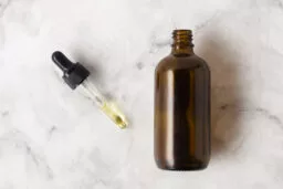 flat lay bottle oils with pipette